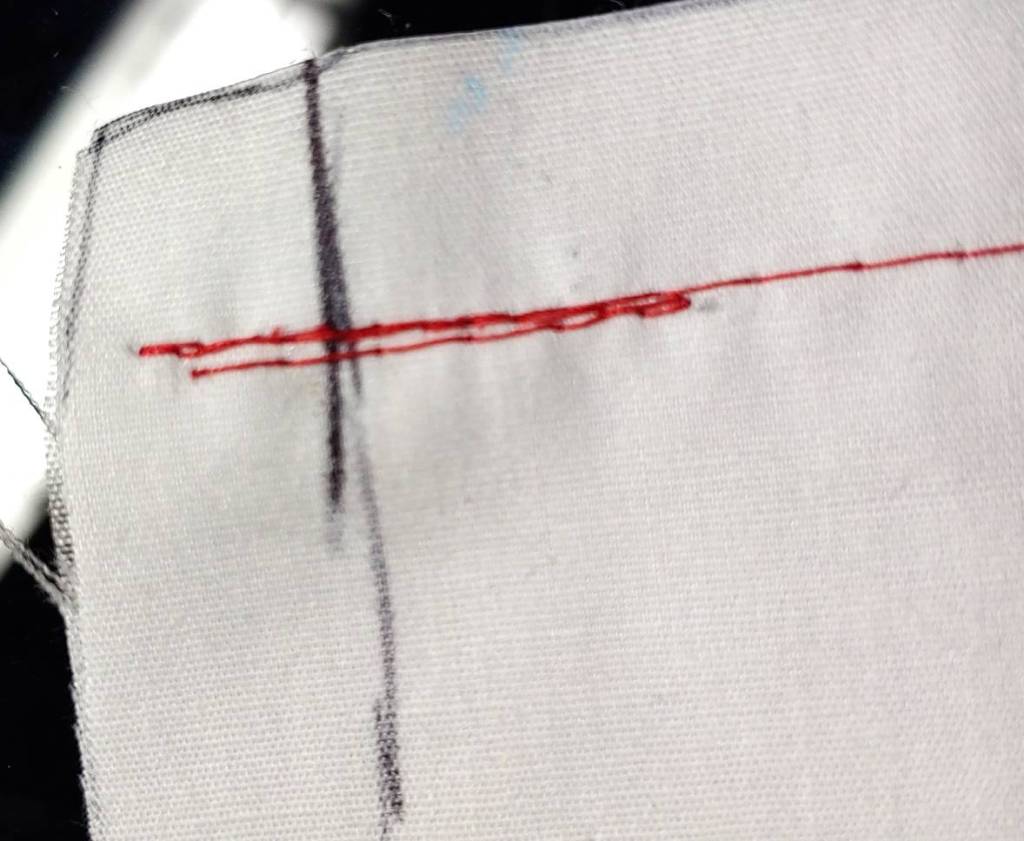 A sewn backstitch. The stitch is sewn back and forth before continuing along the seam.