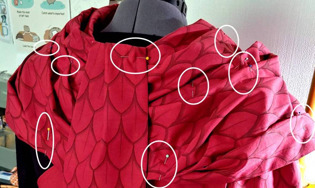 A pinned scarf that will be tacked to hold it in place