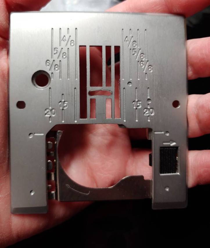 A needle plate with seam allowances marked