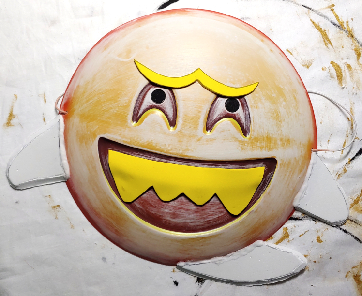 Gluing the foam details on the mask. I think it's laughing at me.