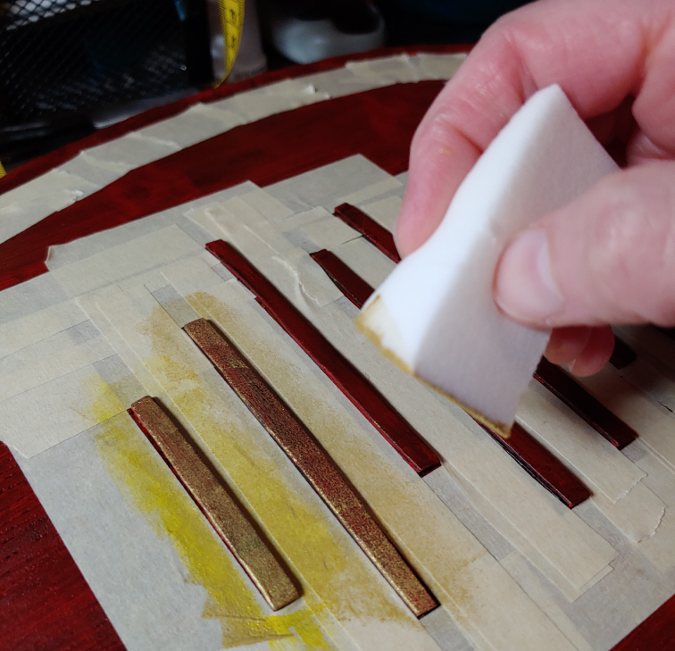 Weathering the accents with a makeup wedge to make them look old