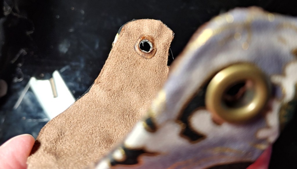 Adding eyelets and gluing the inside to keep it from tearing at your wig