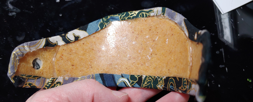 Fabric wrapped around the edges of the ornament, glued and trimmed