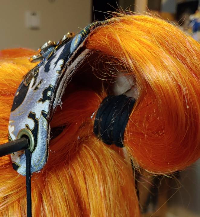 Decorative ties hide the elastic and also help secure the hair stick