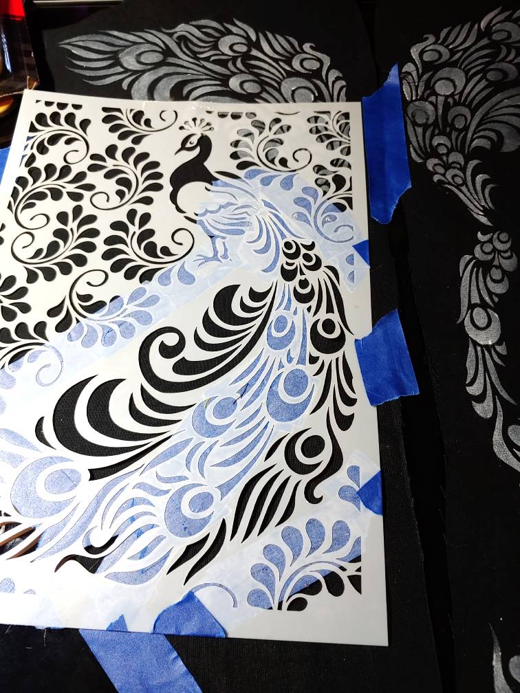 Stencil flipped over and taped back down on the fabric