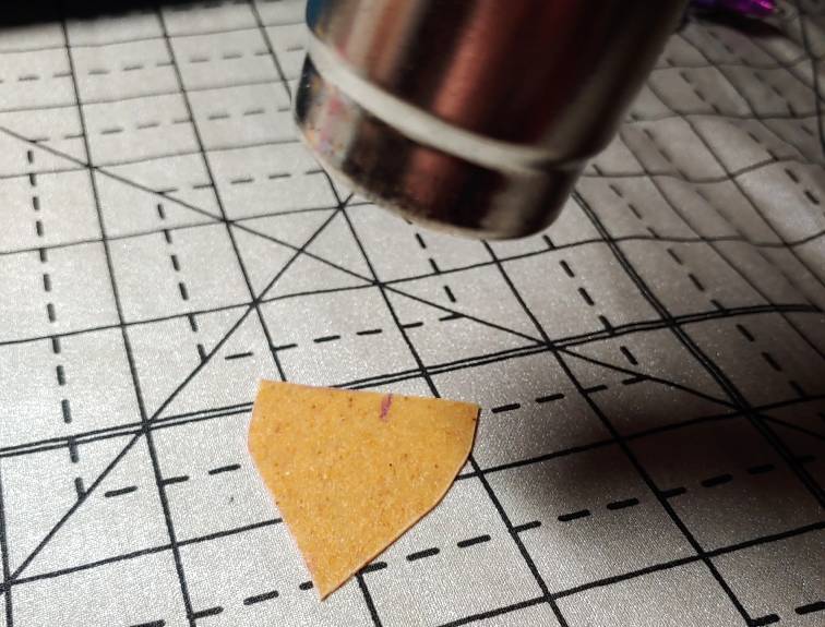 Heating up Worbla with a heat gun on a heat-resistant mat