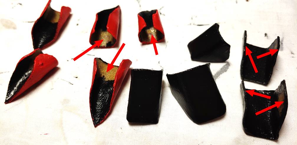 Painted pieces with the glue points visible. Some are marked with red arrows