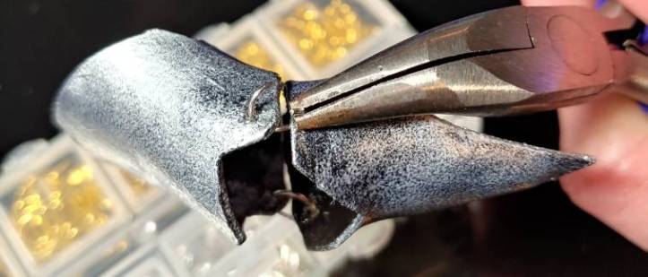 threading the jump ring through the segment using pliers