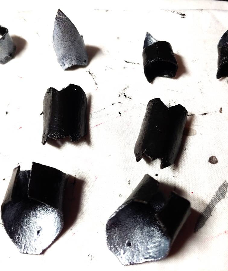 Finger segments in progress of being painted metallic silver