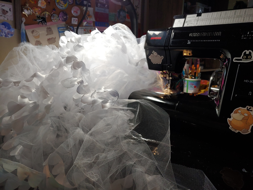 Sewing machine with a ton of petticoats taking over the desk