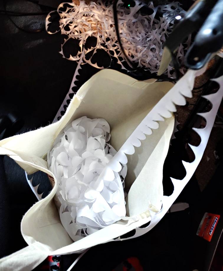 a ribbon catcher made out of a shopping bag clamped to my desk