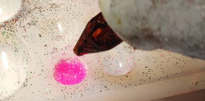 Use the glue gun to add glue to the mold