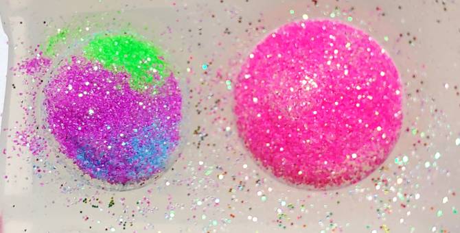 a multicolored gem next to a single colored