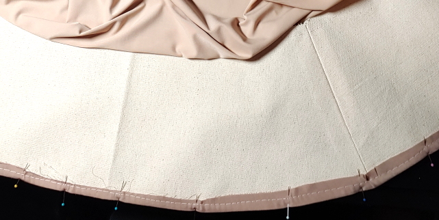 bottom edge of the inner basque is rolled over the canvas, pinned, sewn down, then pressed.