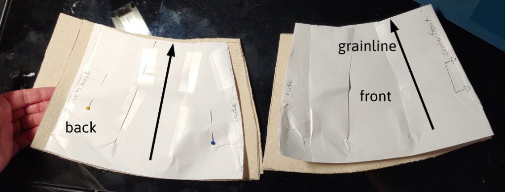 pieces of the basque cut out of duck canvas, the grainline marked with arrows