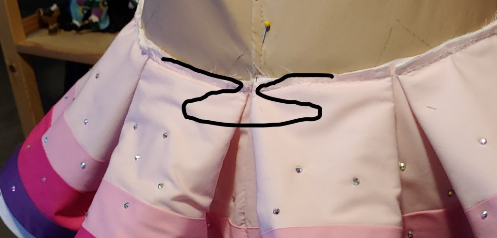 showing how the pleats meet up at the back seam.