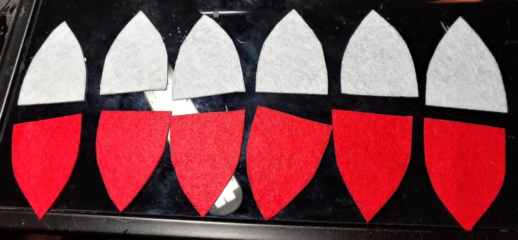 12 pieces of Pokeball on the desk. 6 red and 6 white.