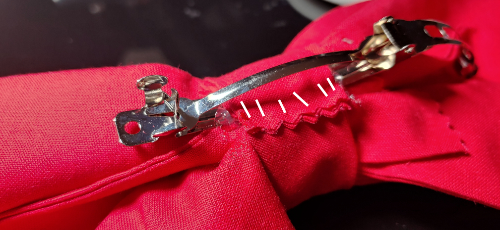 Barrette slipped into the hem tape and secured with whip stitches (in white)