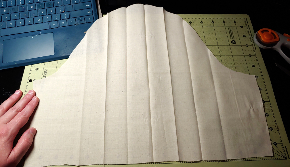 Sleeve unfolded with the iron creases marked on the fabric.