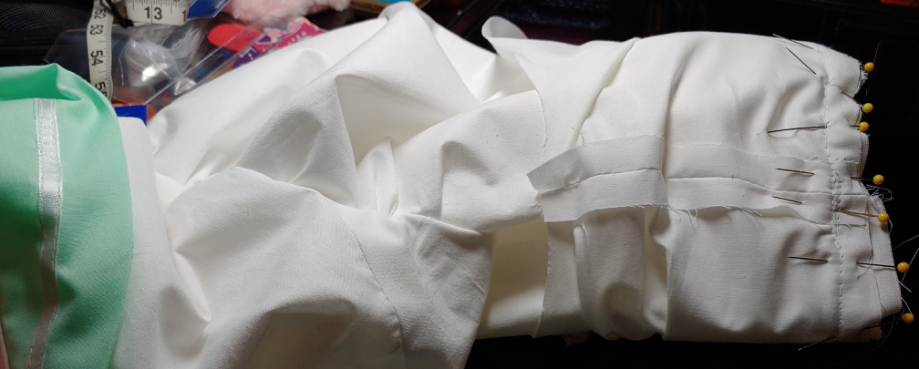 Sleeve layer sandwich assembled, pinned, and sewn down.