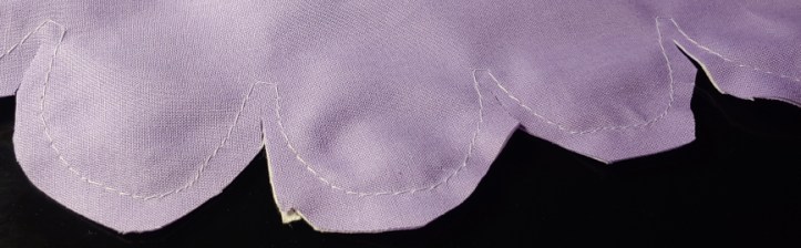 Trimming the edge of the fabric near the stitches