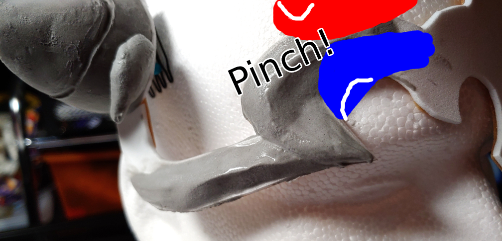 Pinching your fingers together to create a ridge shape.