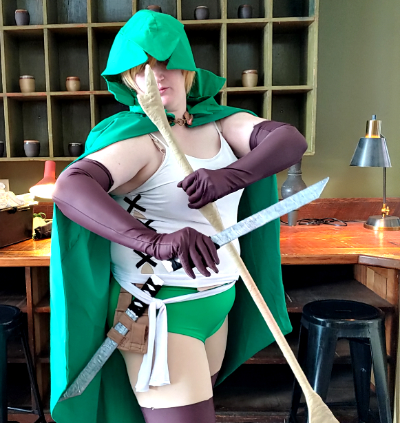 Decoupaged daggers and stick props used with a DanMachi cosplay. They're crossed here in a battle pose.