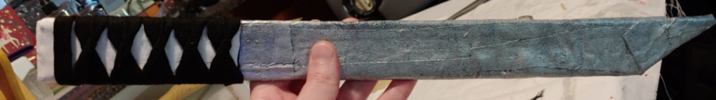 Some of the strips are visible in the paint work, leaving strange lines on the sword's blade