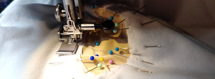 Carefully stitching around the cutouts about 1/8" away from the edge.