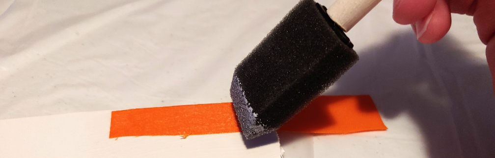 Brush the foam brush along the fabric's surface to stick it in place