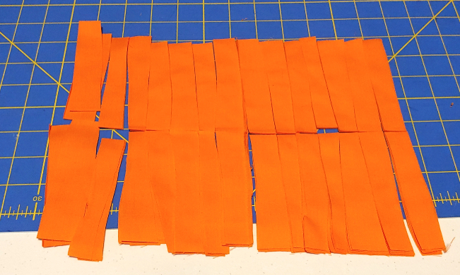 strips of bright orange fabric, ready for decoupage