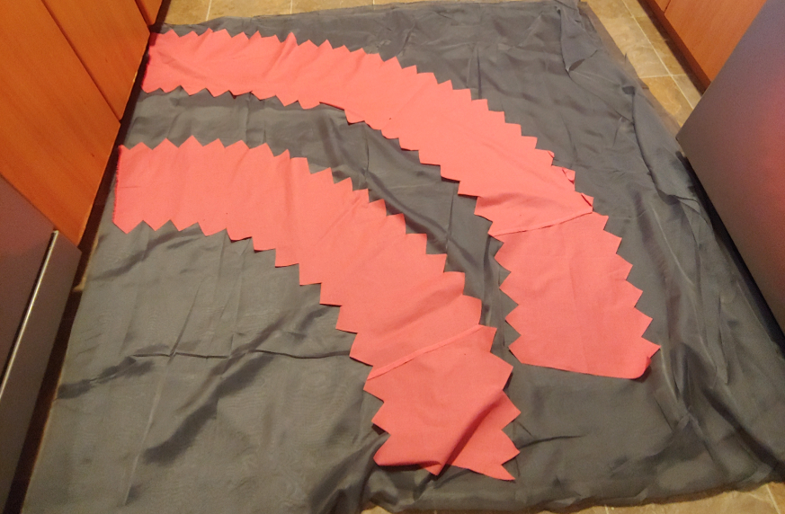 Middle two tiers laid out on medium gray fabric on the kitchen floor. there is space between the tiers.