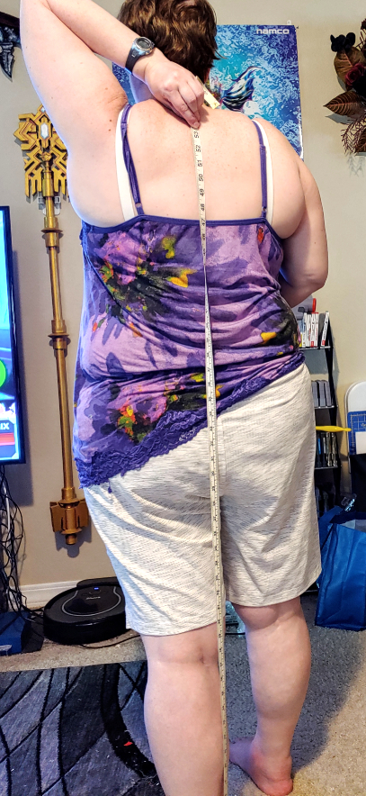 Measuring your own back with a tape measure.