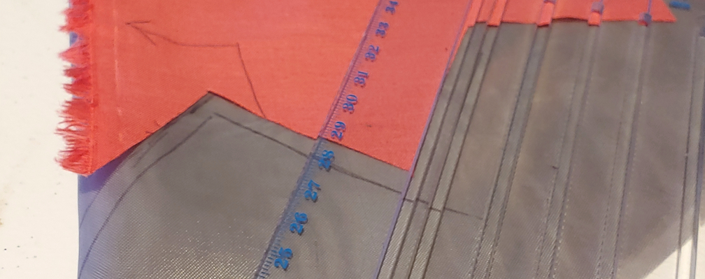 Adding ¼” seam allowance using a tailor's ruler as a guide.