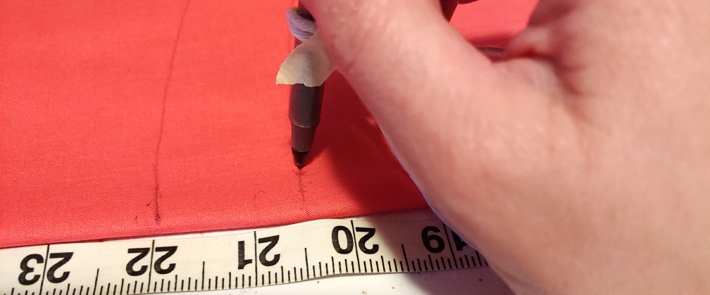 Drawing two lines. The pen is taped with the cording, drawing a line at 22" and at 20.5"