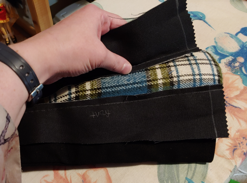 Ironing the two sides down. A sleeve roll is inside the boot to assist with ironing this seam flat