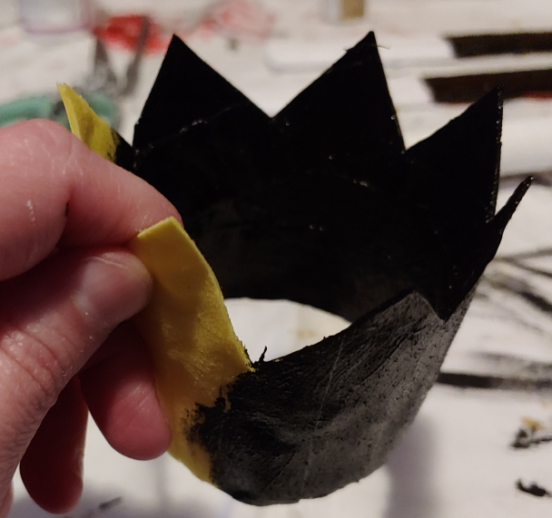 Painting a black base coat for a metallic crown. The black makes the top coat appear more like actual metal