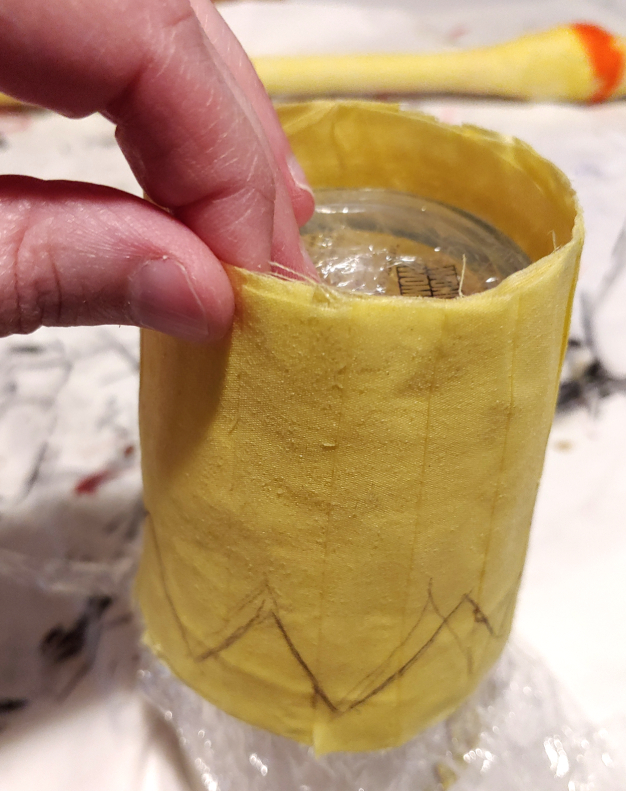 Pulling the crown off the glass by the edges of the decoupage. Use the bottom of the glass for leverage as needed.