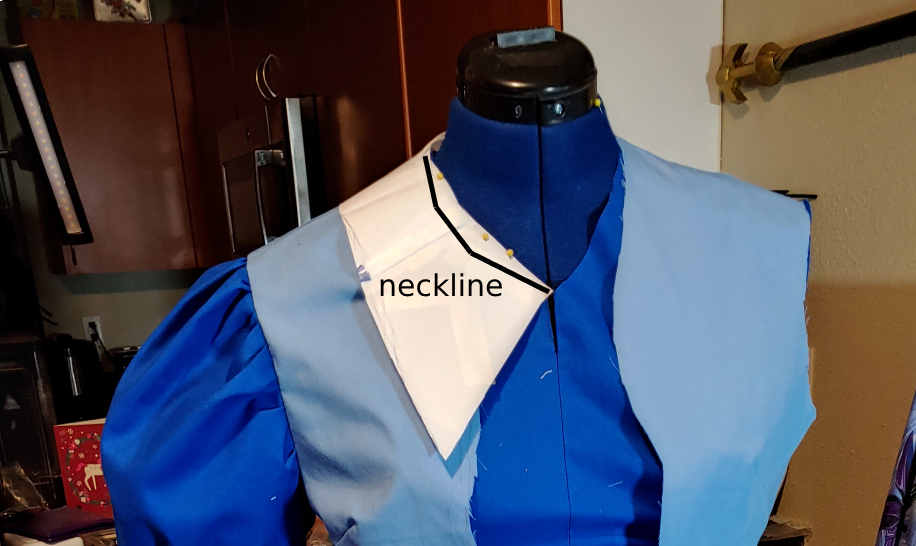 A collar patterned out of paper. Neckline is marked in black to show placement