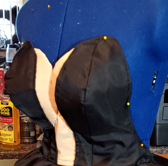 Finished tatas tucked underneath a black corset.