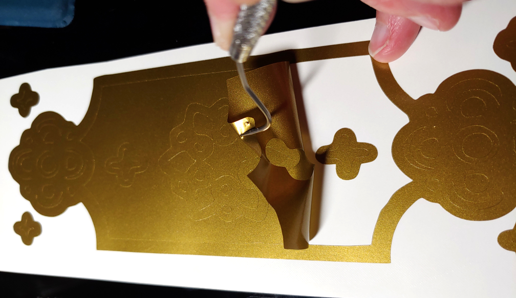 Spearing and pulling off a large center section. The weeding tool is shaped like a hook, the pointy end speared partially into the PSV