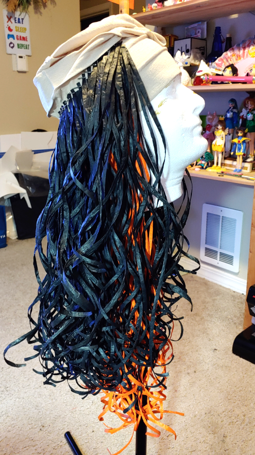 Finished lower section. Black raffia is glued over the orange with a gap at the front and a section left unglued at the top.