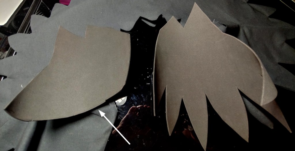 Feathers trimmed off the foam to make a smooth edge. Arrow points to where the trimming happened.