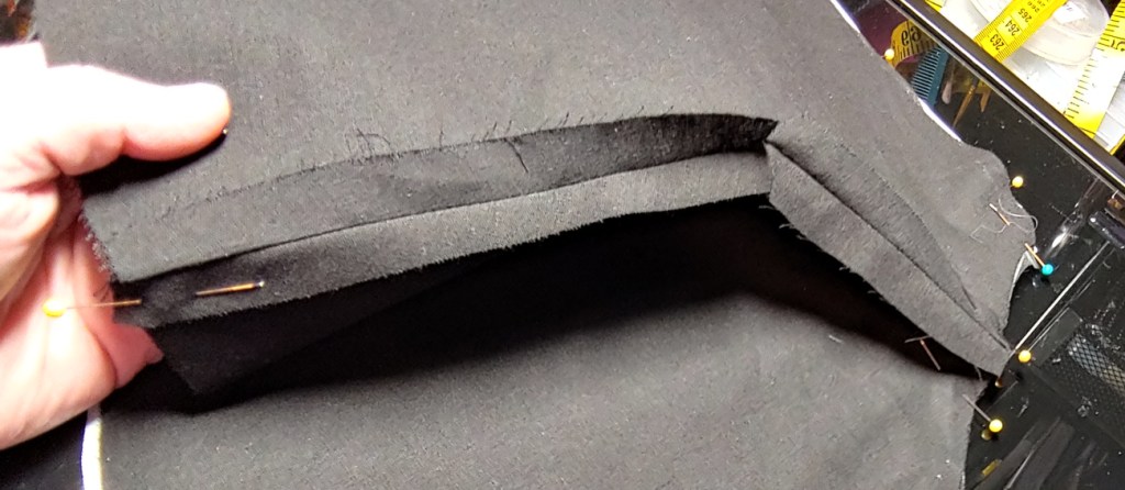 Shoulder seam ironed open and clipped at the bend to prevent pinching and buckling in the fabric