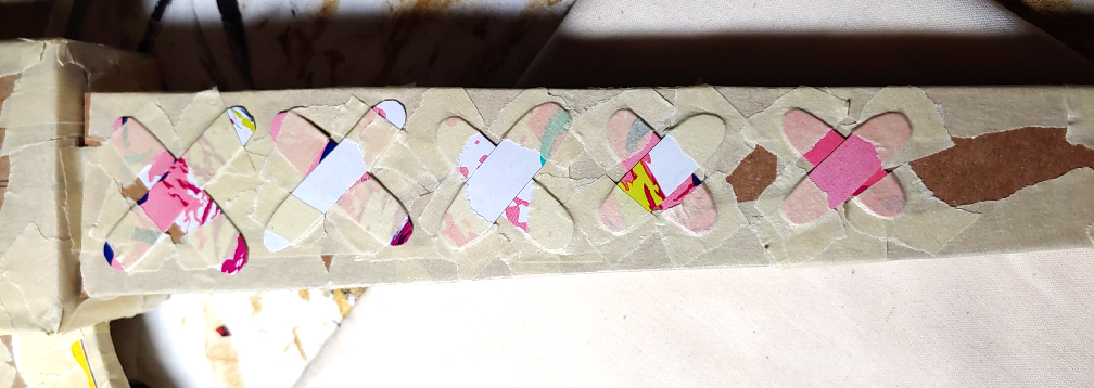 X-shaped laces taped to the front face of the square pipe