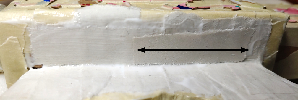 Perpendicular strips added over the previous strips. An arrow shows the direction of the strips