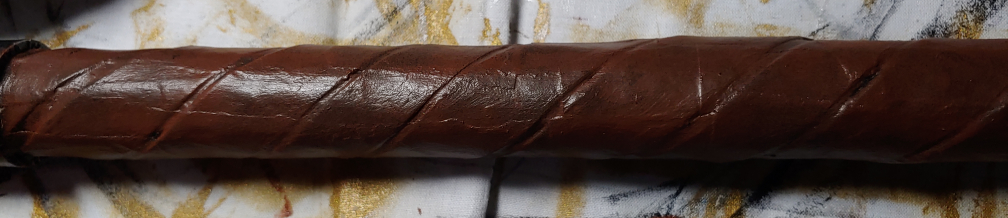 Painted axe handle using a sponge to make it look like worn leather