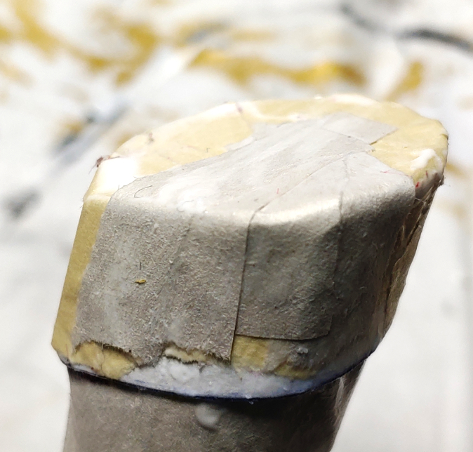 Tiny strips for a smooth end cap. Thin strips of paper stretch across the end cap and over the edge, creating a smooth border around the circular cap.