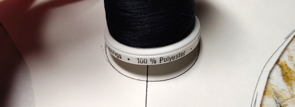Tracing the indentation onto the pattern paper using a spool of thread as a guide