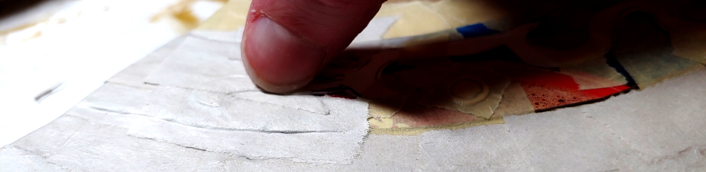 Digging the thumbnail into the groove to create a detailed edge. Pressing the nail into the edge creates a crease in the paper.